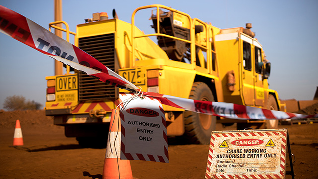 Danger sign indicating oversized crane vehicle