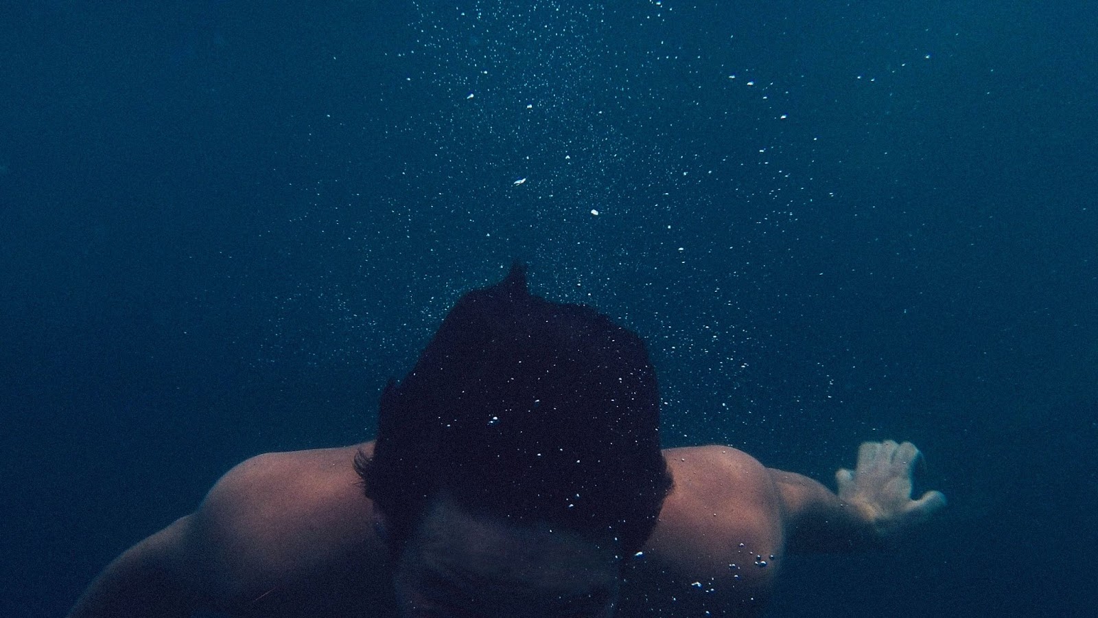 a man swimming under the water