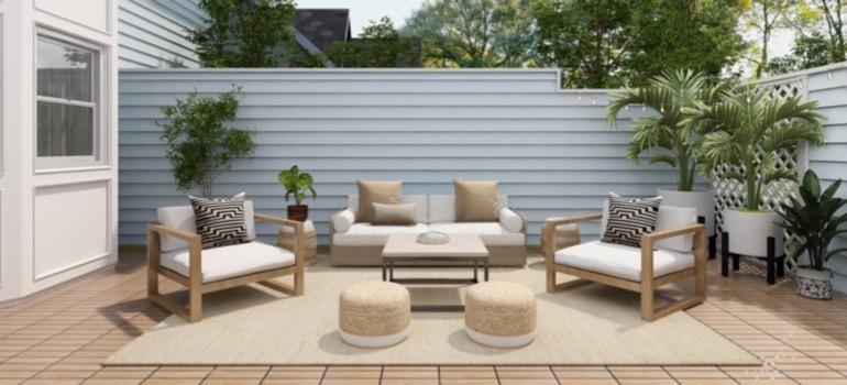 A backyard patio with white furniture