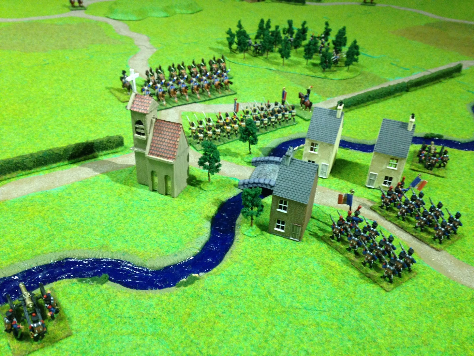 Initial French setup defending town. Light Infantry are in forest at top left, Heavy Cavalry guarding the main road, and artillery batteries each side of the town behind river. French need to hold the bridge for 15 turns to ensure it is demolished