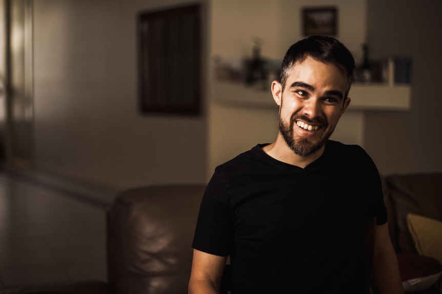 Jame Teh wearing a black t-shirt, smiling.