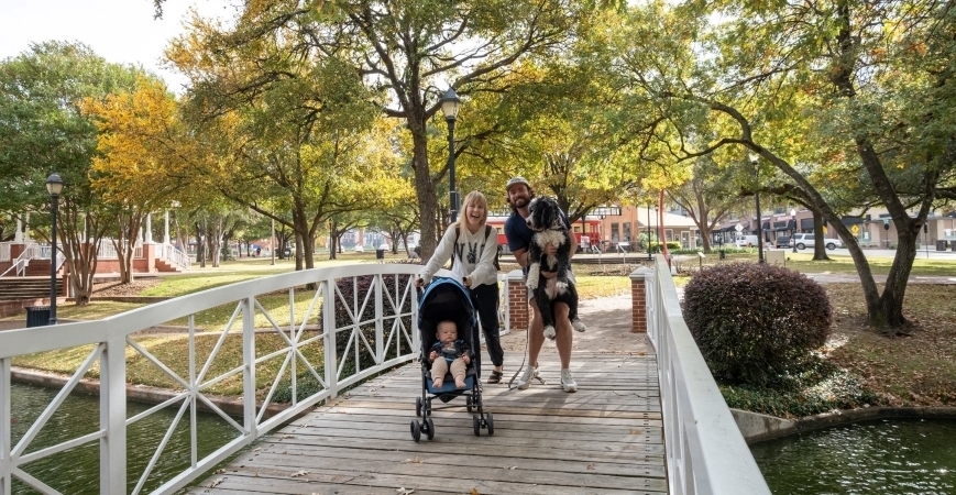 A young family taking a walk in Plano, TX.