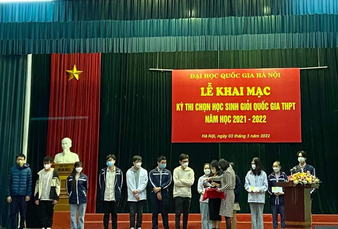 A group of children standing on a stage with a sign behind them</p>
<p>Description automatically generated with low confidence