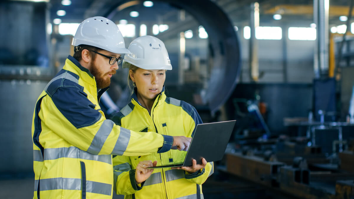 Engineers discussing something on a laptop