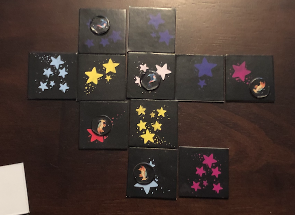 Constellation tiles laid out with dinosaurs on them.