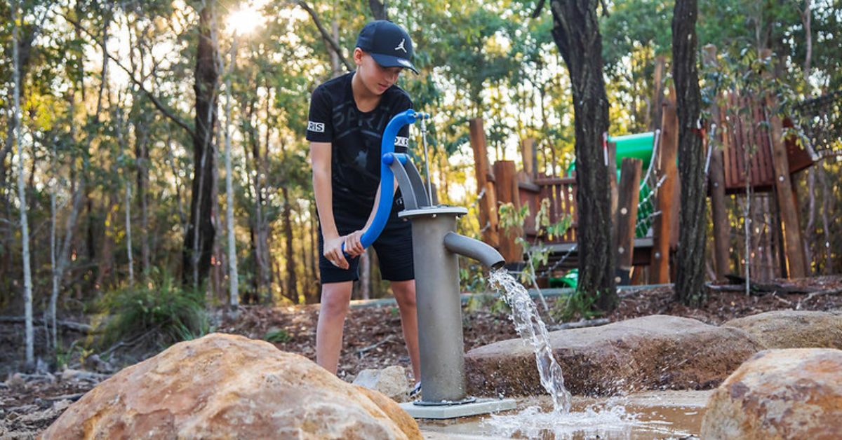 Water play in nature-play playground  