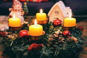Yellow candles in a holiday décor arrangement