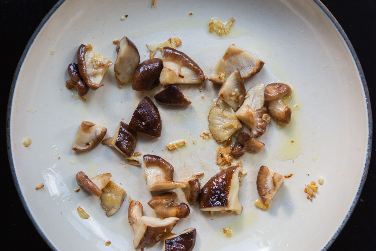 shiitake mushrooms cooking in a skillet