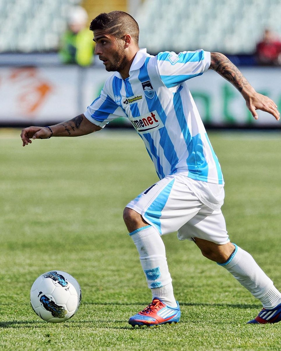 Full view of insignia rocking his R9 haircut with some slashed look at the side and a tattoo to spice things up