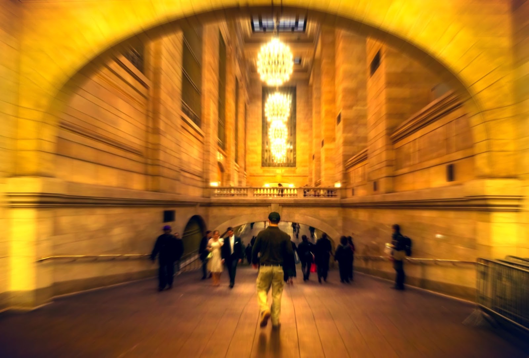 A group of people walking in a tunnel</p>
<p>Description automatically generated with low confidence