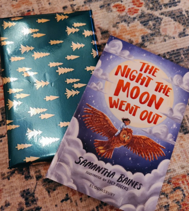A wrapped copy and normal copy of Ms Baines' book, The Night The Moon Went Out