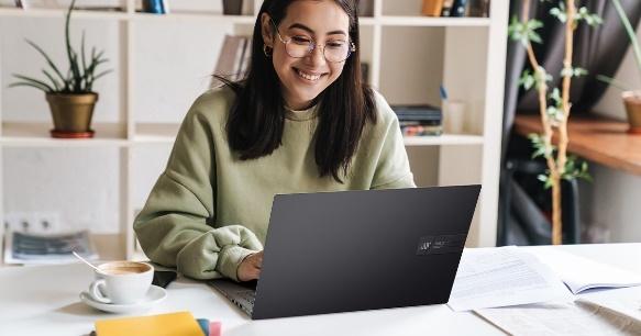 A person sitting at a desk with a computer

Description automatically generated