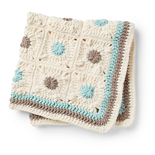 crochet baby blanket made with squares in ceam, blue and brown