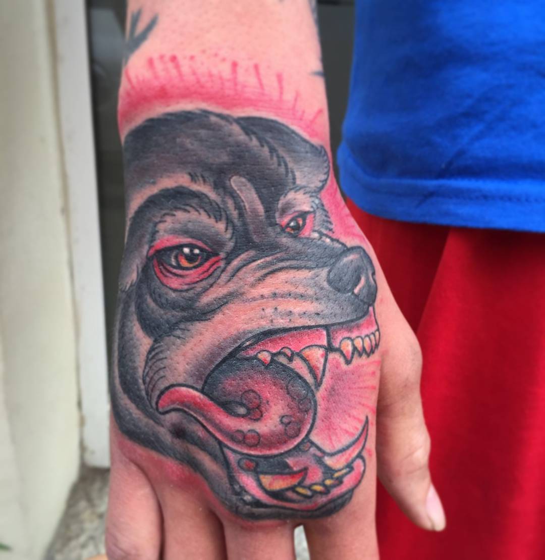 Red And Black Wolf Tattoo On Hand