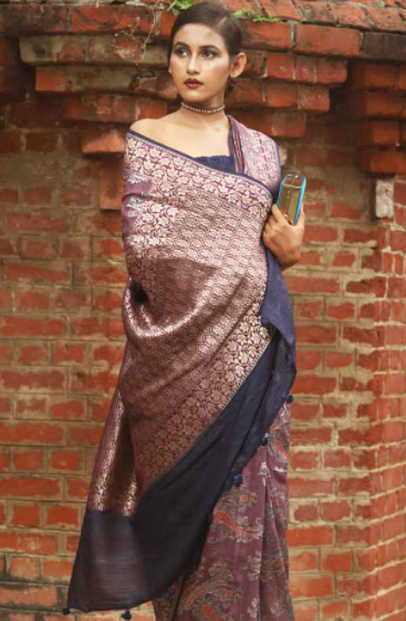 A woman draped into a handwoven purple tussar georgette silk saree with Mughal inspired motifs