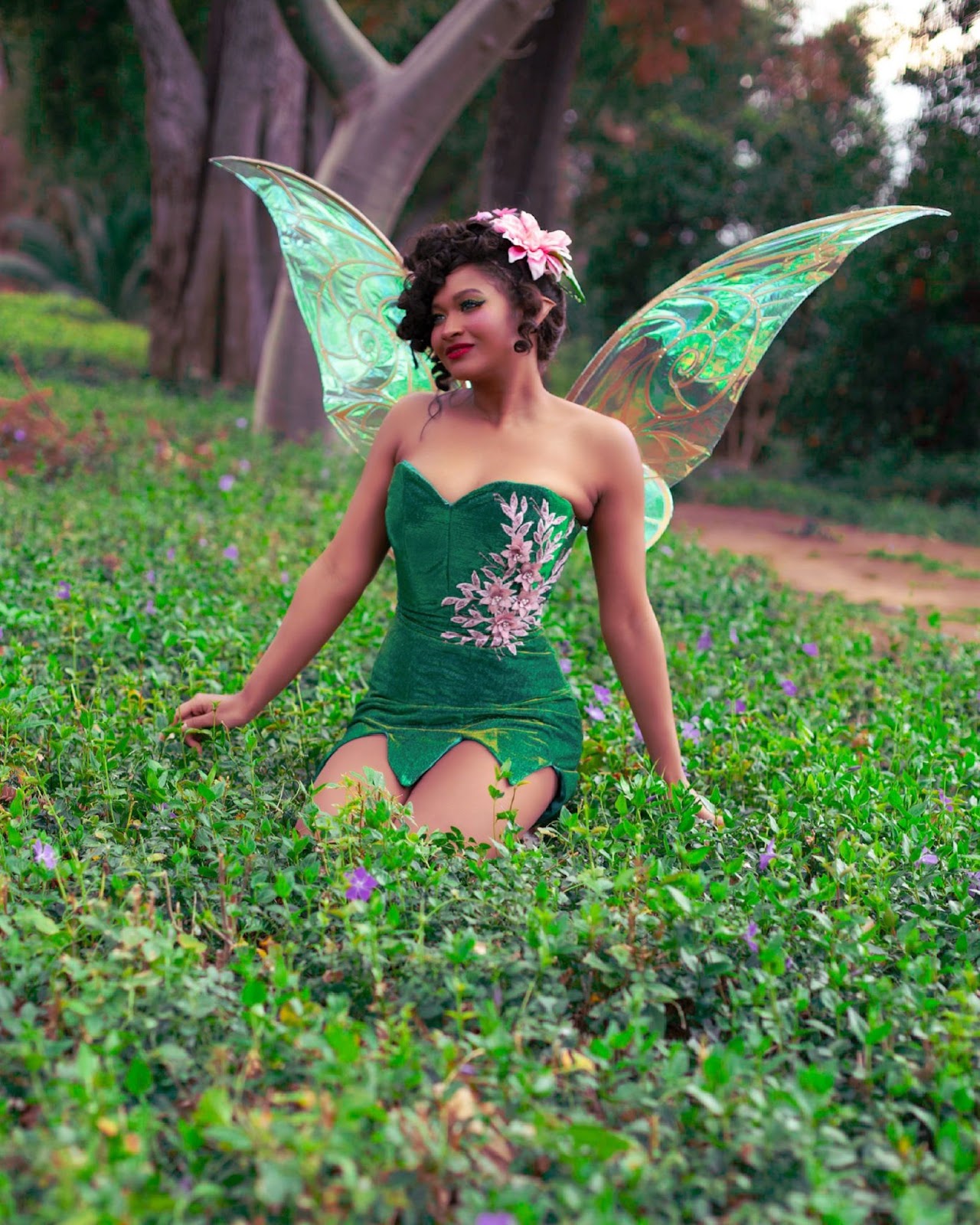 tinker bell cosplay from peter pan and tinker bell. green dress, fluorescent wings, lily pad head dress.