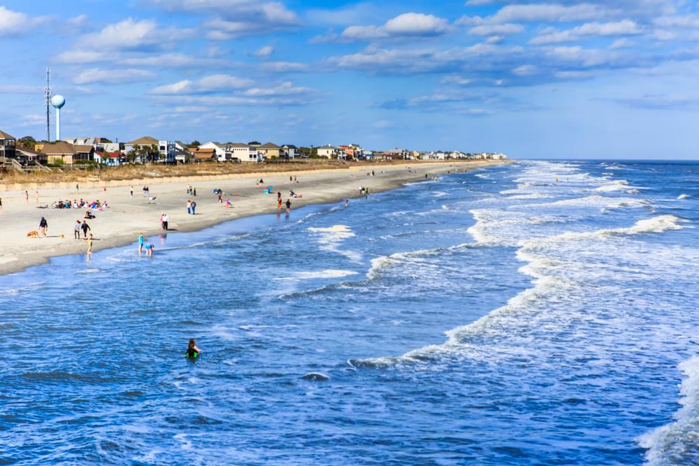 FOLLY BEACH, SC/USA - MARCH 30, 2015:  Residents and tourists flock to the Atlantic Ocean at Folly Beach, also known as the "edge of America," near Charleston in South Carolina.