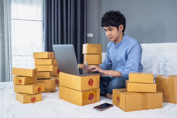 man-surrounded-by-boxes-using-laptop