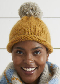woma wearing a knit hat with pom pom