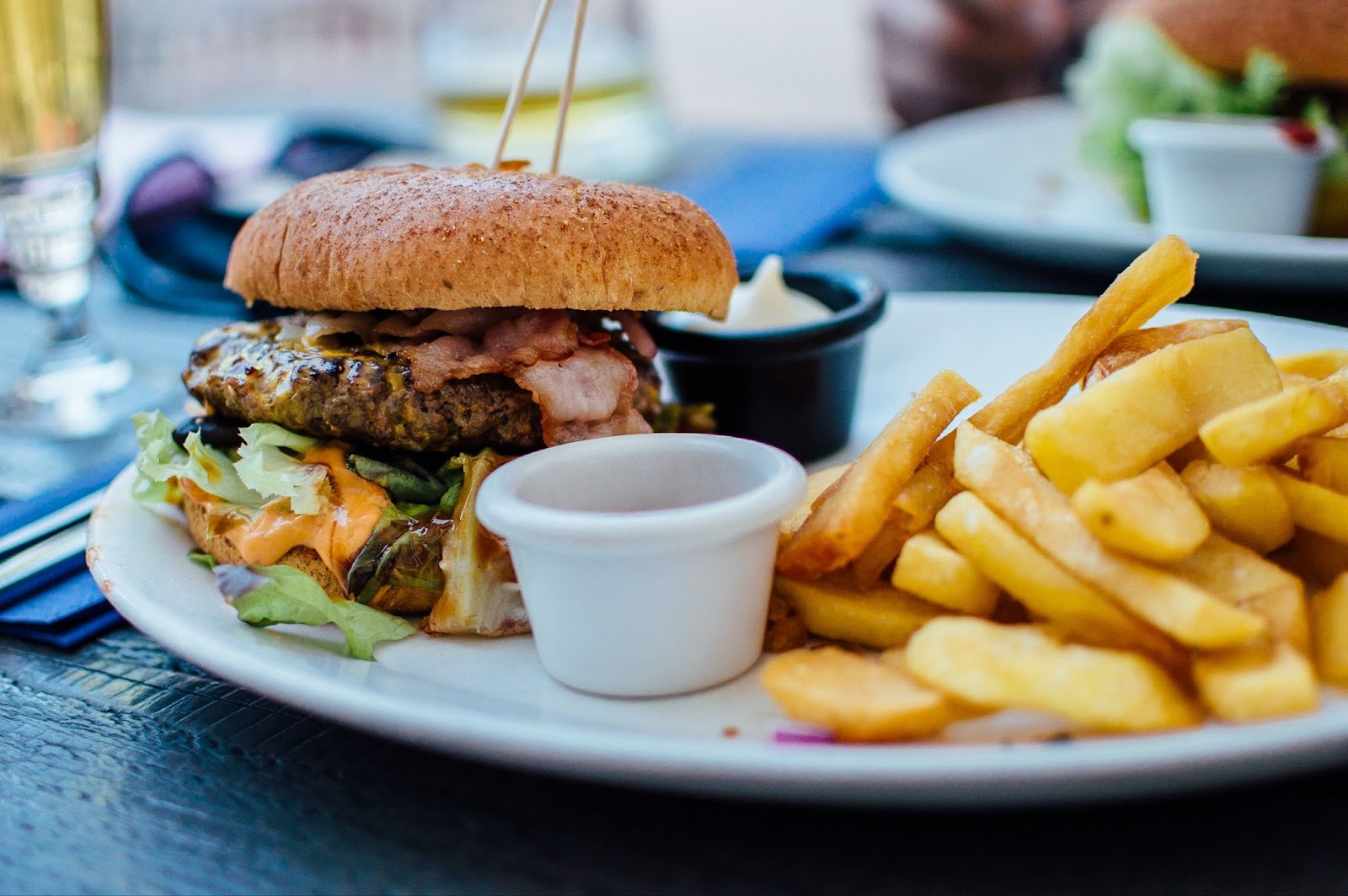 A heart burger and fries on a white plate from Central Kelowna, voted best burgers in Kelowna in 2023