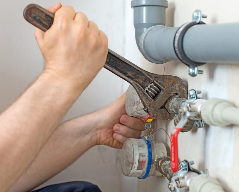 Plumber fixing pipe work